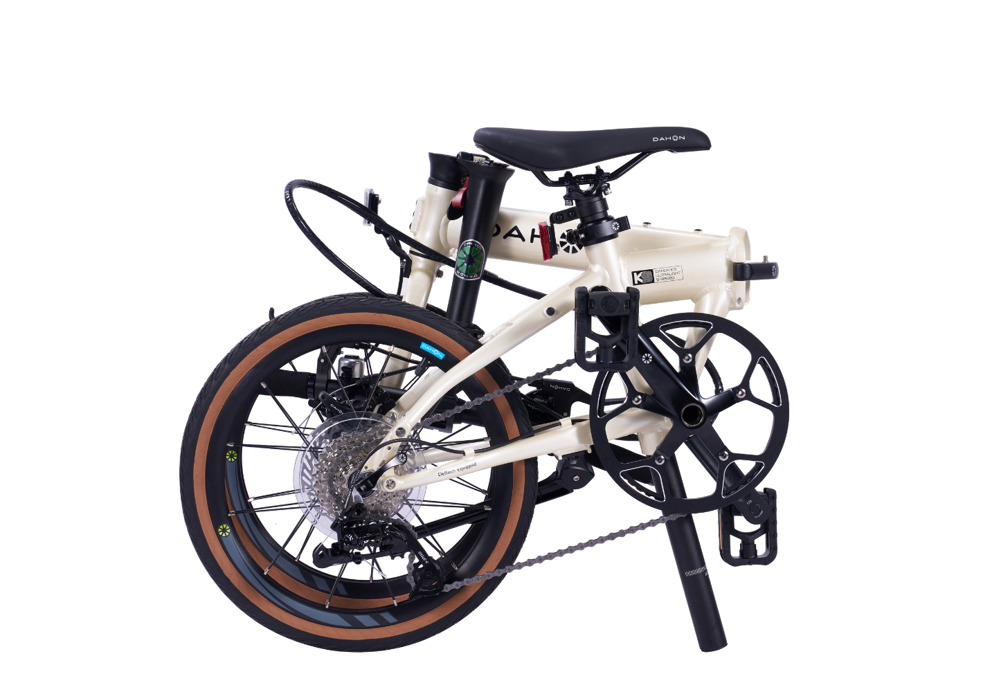 Folded DELTECH K9 folding bike with cream frame, black components, and brown tires