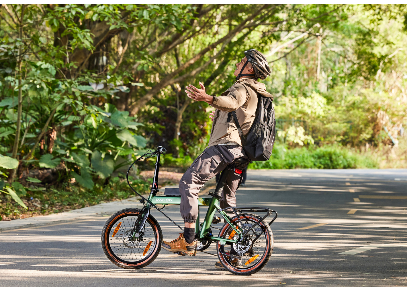 Green DAHON foldable electric SUV bike with orange accents and silver rack, ready for urban travel.