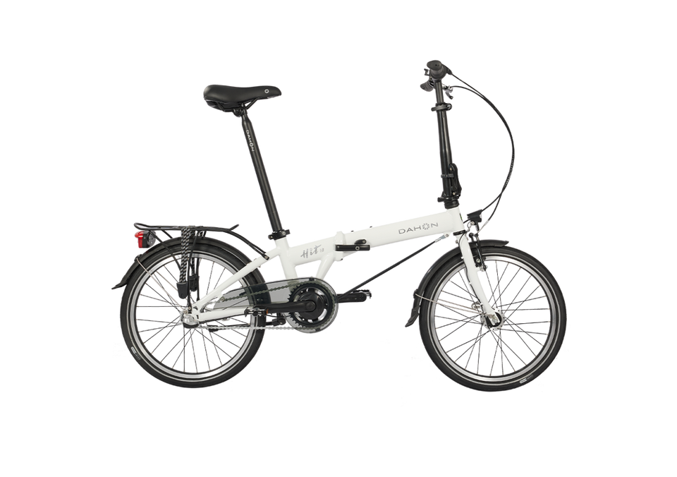 HIT i3 - White Dahon HIT i3 folding bike with black seat, handlebars, and tires. Features rear rack and fender. Ideal for urban rides.