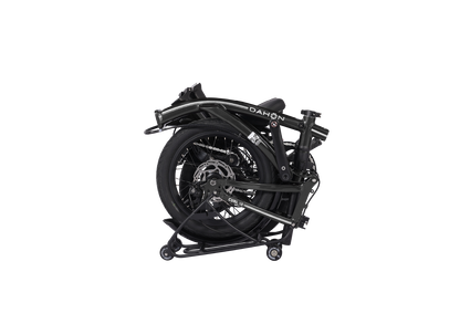 Black Dahon Curl i8 compact folding bike folded on a stand